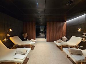 a wellness room with white chairs and tables at Hotel la Palma au Lac in Locarno