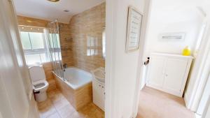 a bathroom with a toilet and a sink and a shower at Georgeham Windsor Cottage 3 Bedrooms in Georgeham +18 photos