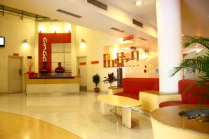 a lobby of a hospital with a red couch and a table at Ginger Pune - Pimpri in Pune