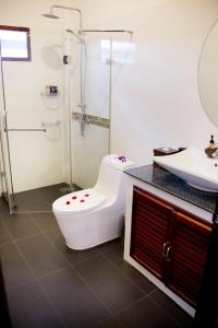 a bathroom with a toilet and a sink at Banburi Villa in Ao Nang Beach