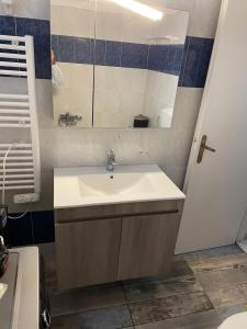 a bathroom with a sink and a mirror at Stadium Apt in Kos