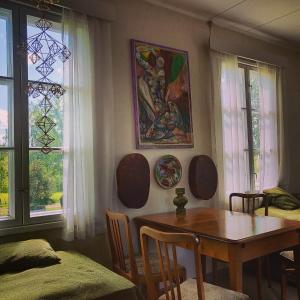 a dining room with a table and a painting on the wall at Olo Tila in Kurikka