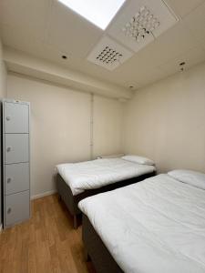 Postel nebo postele na pokoji v ubytování Nomad City