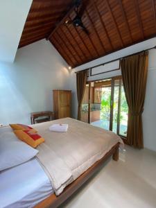 Postel nebo postele na pokoji v ubytování Bali Asli Guest House by EPS