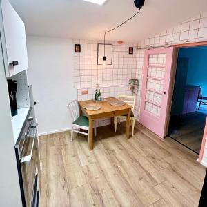 a kitchen with a wooden table in a room at Schlafstall Brooksen in Bruchhausen-Vilsen +8 photos