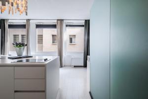 a white kitchen with a sink and a window at The Boutique Houses - Iconic Suite in Galleria Duomo with private parking in Milan
