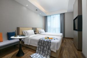Voodi või voodid majutusasutuse 希亚途花园酒店 toas