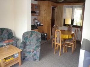 a living room with two chairs and a table at Ferienwohnung "Ganz 1" in Vipperow
