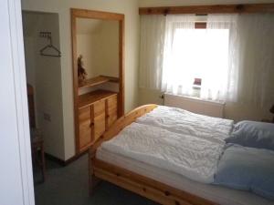 a bedroom with a bed and a dresser and a window at Ferienwohnung "Ganz 1" in Vipperow