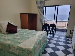 a bedroom with a bed and a view of the ocean at Ugu Home Feeling Guesthouse in Port Shepstone