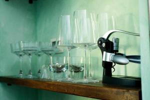 a row of wine glasses sitting on a shelf at Loft 1855 'centro cittá' in Domodossola