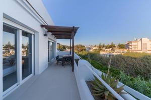 a balcony of a house with a table and chairs at Villas Flamenco Beach Conil in Conil de la Frontera