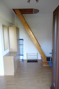 a room with a staircase and a bench in a room at Ferienwohnung "Meißner" in Rechlin +12 photos