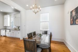 a dining room with a table and a kitchen at Spacious 3BR Garden District Home w Pool & Balcony in New Orleans +41 photos