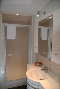 a bathroom with a sink and a shower at Guesthouse Les Tilleuls in Fleurus