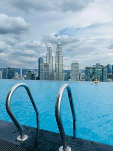 a swimming pool with a city skyline in the background at Platinum Suites KLCC SKY WORLD in Kuala Lumpur