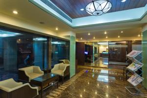 a lobby with chairs and a table in a building at Ginger Thane in Thane