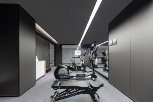 a gym with treadmills and machines in a room at Atour X Hotel Xiamen Exhibition Center Gudishi Station in Xiamen