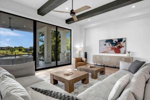 a living room with a couch and a table at Ellen Lake Luxe with Concierge Services in Kingsland