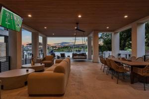 a living room with a couch and tables and chairs at Ellen Lake Luxe with Concierge Services in Kingsland