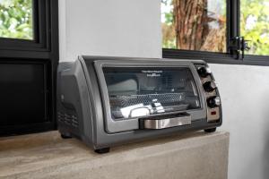 a television sitting on a ledge next to a window at Casa Algarrobo relaxing farm stay in Puerto Rico in Cerro Gordo