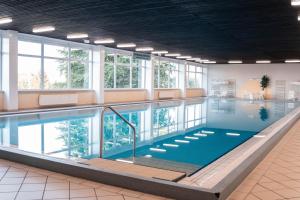 a pool in a building with a swimming pool at Terrassenhaus Waldblick 637 in Hohegeiß