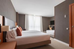 ein Hotelzimmer mit einem großen Bett und einem Fenster in der Unterkunft Acta Sant Just in Sant Just Desvern