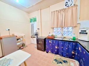 a kitchen with a sink and a washing machine at Homestay Bourgenvilla Sura tengah Dungun Terengganu in Kampong Sura Tengah