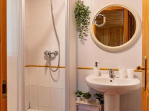 a bathroom with a sink and a mirror at Las Casitas del Pinar in Bayubas de Abajo +34 photos