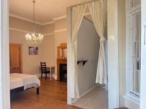 a bedroom with a door leading into a room at Lindela House in Kokstad