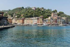 a large body of water with buildings on a hill at Villa Peninsula in Portofino