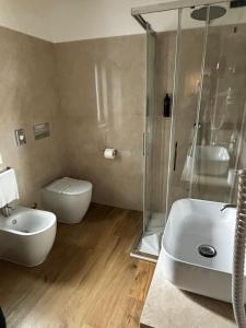 a bathroom with a shower and a toilet and a sink at Hotel San Remo in Rome