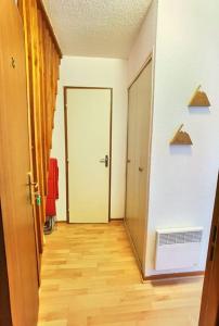 a hallway with a door leading to a room at Duplex au cœur de la station in Ustou