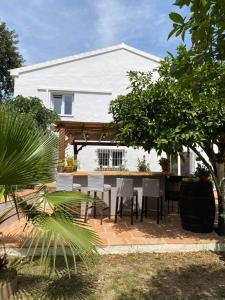a patio with a table and chairs in front of a house at Casa Luna in Tolox