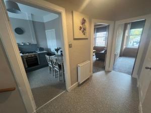 a small kitchen and dining room with a table and chairs at The TWEED in the centre of Melrose in Melrose +11 photos