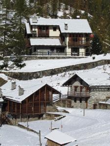 a large building with snow on the roofs at Il Piccolo Residence in Gressoney-la-Trinité