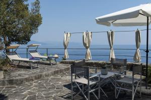 a group of chairs and tables with a view of the water at Villa Peninsula in Portofino +32 photos