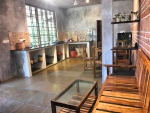a room with a table and some chairs in it at Ashoksfarm in Auroville