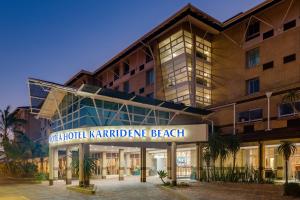 a hotel with a sign that reads the hotel karaderne beach at Protea Hotel by Marriott Karridene Beach in Amanzimtoti