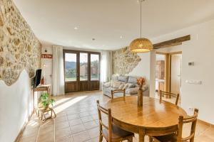 una sala de estar con una mesa y un sofá en La Cabanya de la Rovira - Baix, en Joanetes