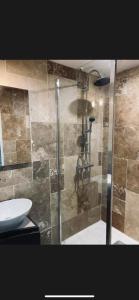 a glass shower in a bathroom with a sink at Parlementaire européen, waken schiltigheim in Schiltigheim +14 photos