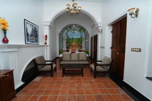 a hallway with a living room with a table and chairs at Pearl bell Villa in Pondicherry