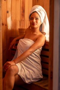 a woman in a towel sitting on a bench at Arushi Boutique Hotel in Kathmandu