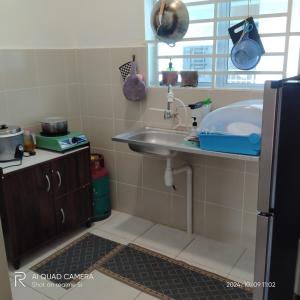 a small bathroom with a sink and a window at HOMESTAY haROOManizz in Kangar +16 photos
