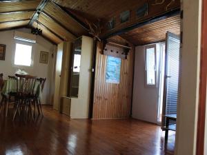a living room with a table and a wooden ceiling at Apartments Ljubo in Stara Novalja +20 photos