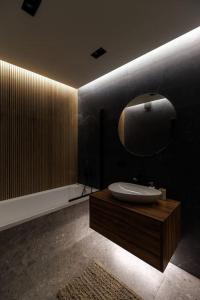 a bathroom with a sink and a mirror on the wall at Circ - 2 bedroom apartment in Staţia de Cale Ferată Visterniceni +20 photos