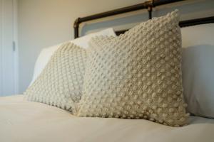 a pillow sitting on top of a bed at The Willow - Studio 15 in Bristol