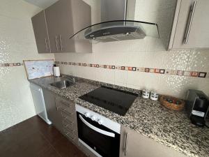a kitchen with a sink and a stove at Suite El Alcázar in Carmona