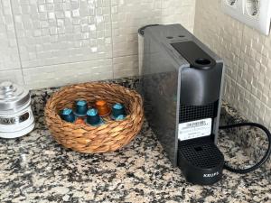 a coffee machine and a basket on a counter at Suite El Alcázar in Carmona +17 photos