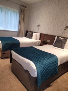 A bed or beds in a room at Arklow Bay Hotel
